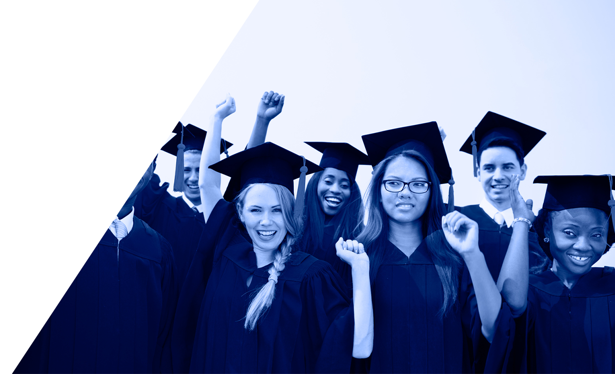 Group of graduates in caps and gowns celebrating with raised fists against a blue background.